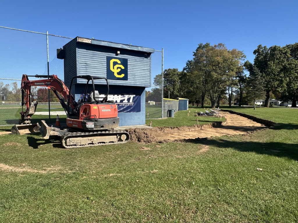 Backhoe digging sidewalks at Baseball/softball fields.