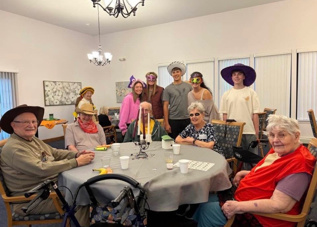 Table of seniors with students in cosutmes