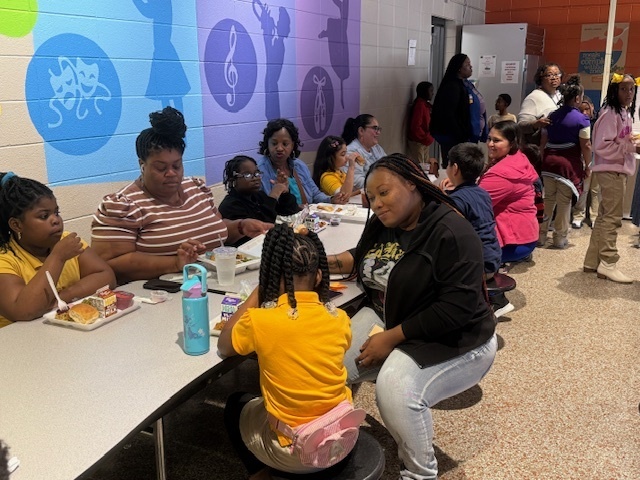 Cook Elementary students enjoy a meal with their parents. 