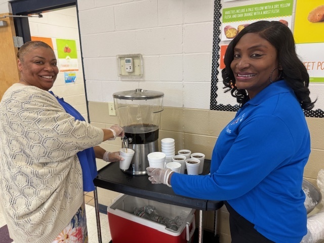CMSD Administration helps serve drinks at the Stokes-Beard Thanksgiving Lunch
