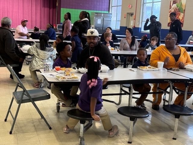 Sale Elementary students and their parents enjoy a Thanksgiving meal