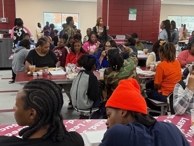 Parents enjoy a Thanksgiving meal with their child at Hunt Intermediate. 