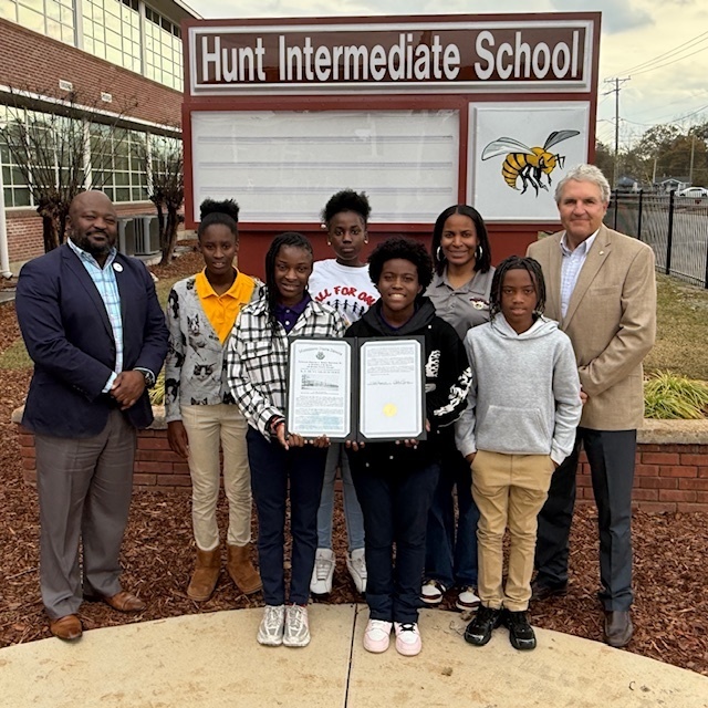 State Senator Chuck Younger presents a proclamation to Hunt Intermediate