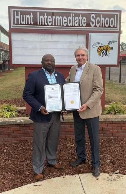 State Senator Chuck Younger presents a proclamation to Interim CMSD Superintendent Craig Chapman
