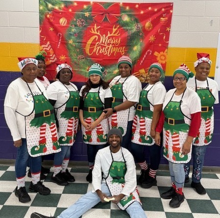 Columbus High Child Nutrition staff in holiday aprons. 