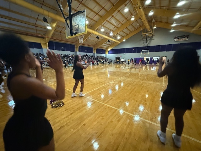 CMS cheerleaders pump up the crowd in a student vs faculty basketball game.