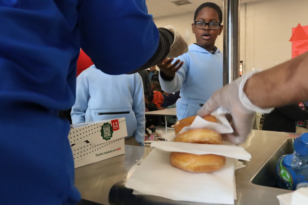 Donuts are served to students at Sale Elementary