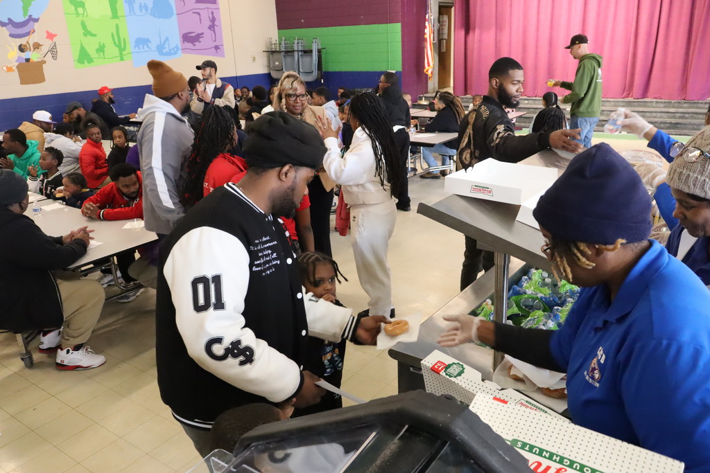 Dads enjoy donuts with their child at Sale Elementary