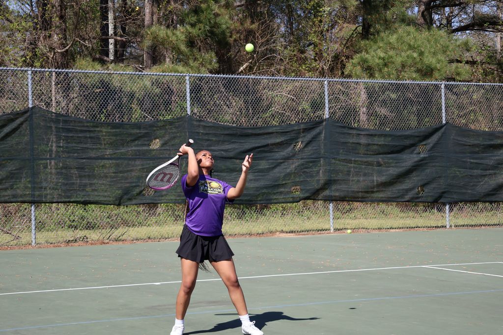 A CHS player serves the ball.