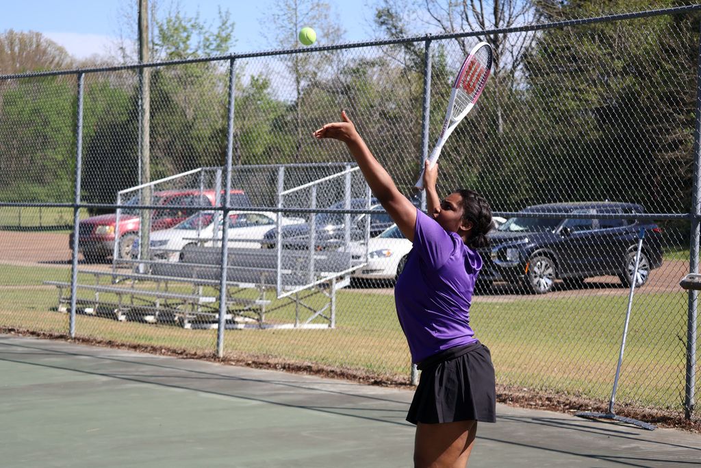 CHS tennis player serves the ball.