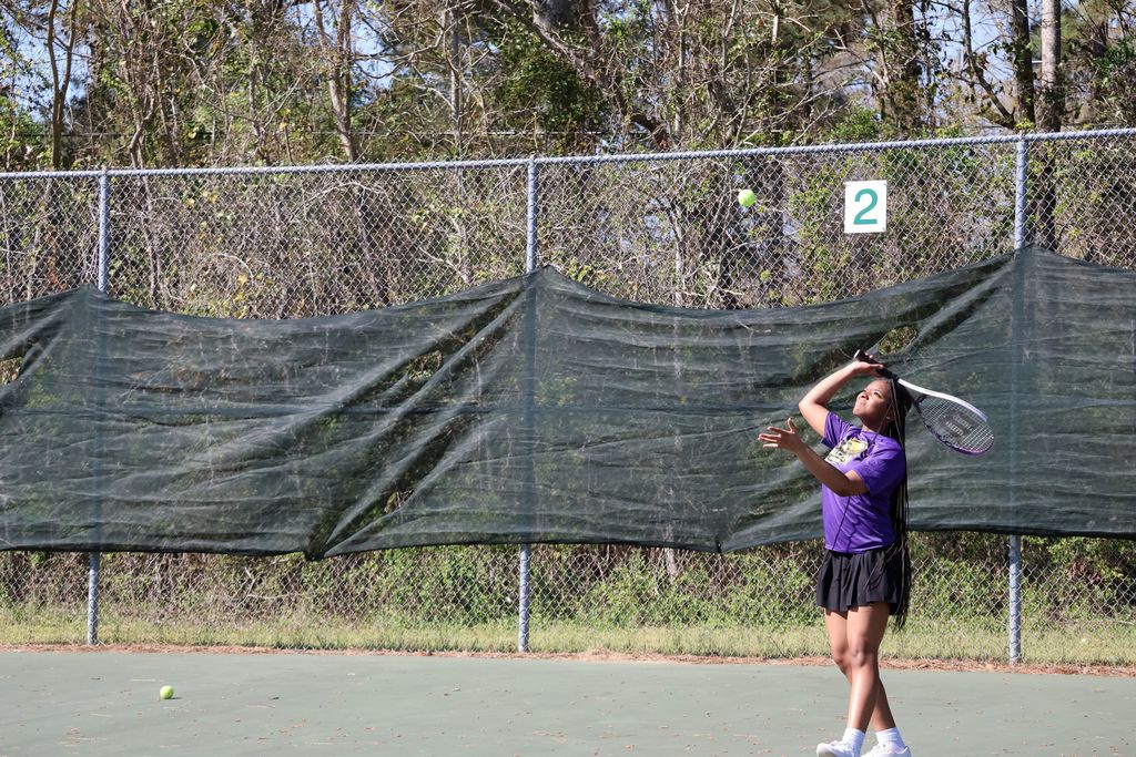 CHS tennis player hits the ball.