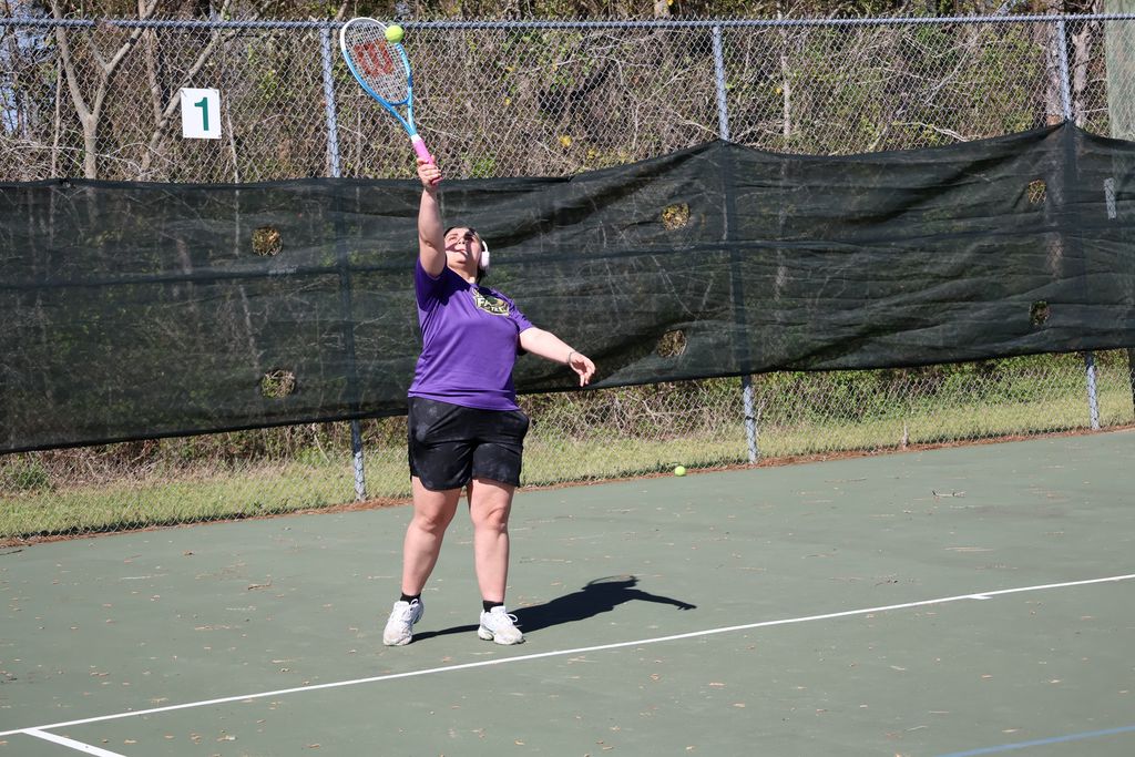 Columbus High tennis player hits the ball. 
