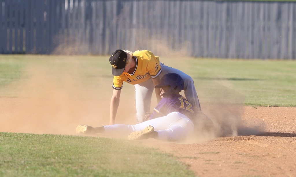 A CHS baseball player slides into second base. 