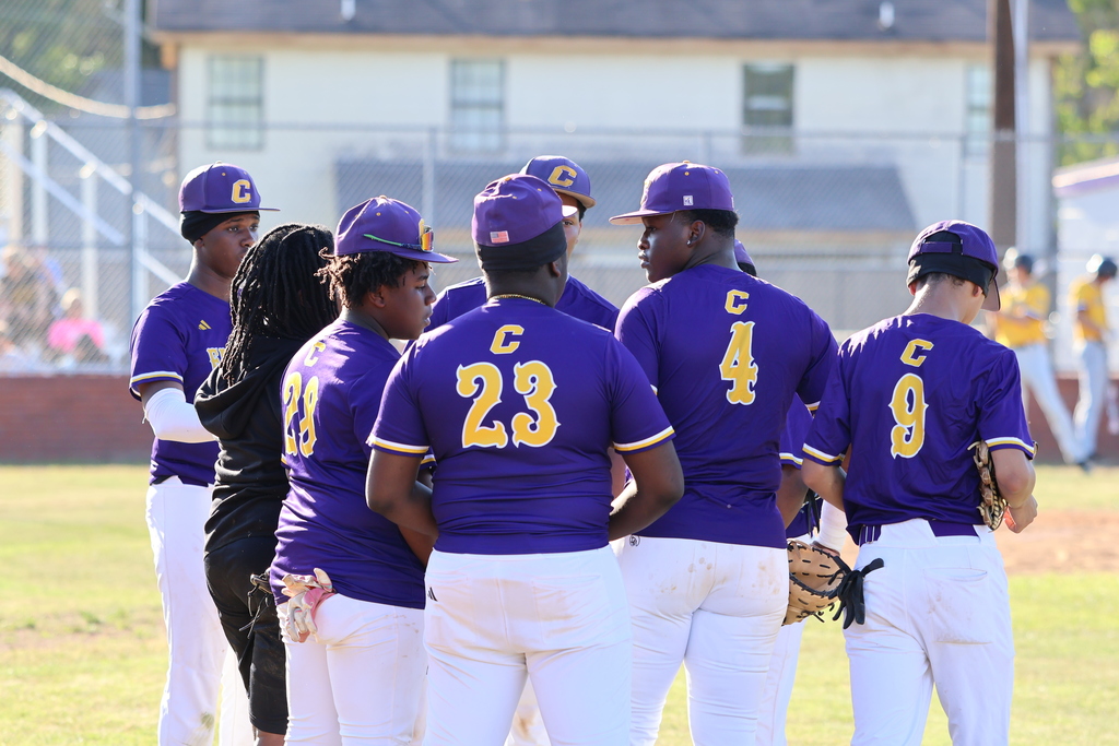 CHS baseball players huddle together on the field.