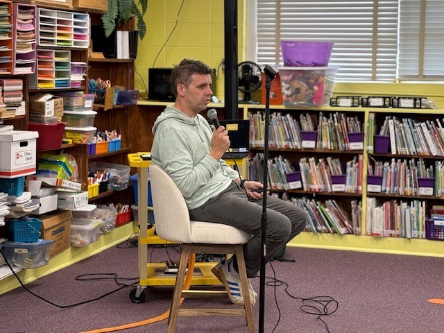 Author Max Brallier speaks to students at Cook Elementary. 