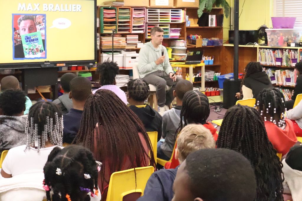 Cook Elementary students listen to author Max Brallier speak. 