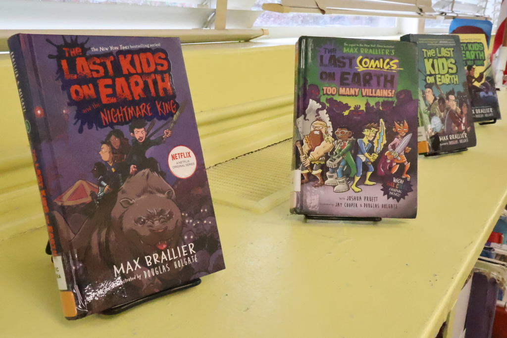 Books written by author Max Brallier on display at Cook Elementary.