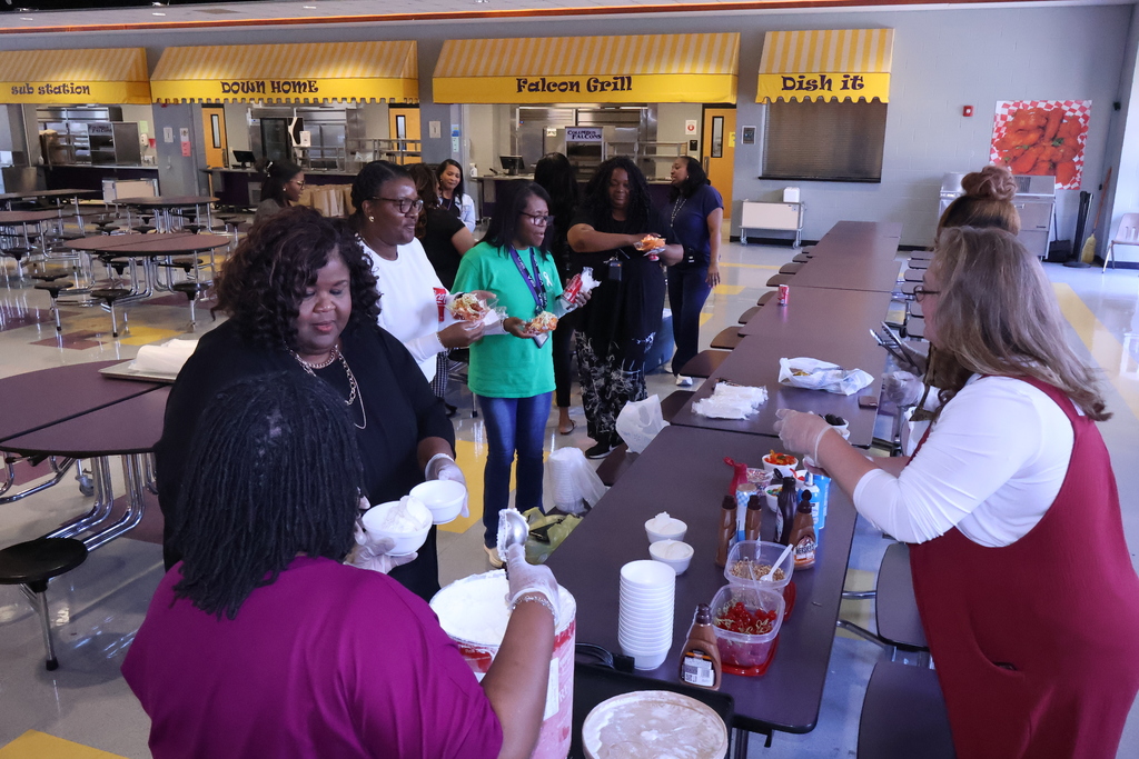Central office staff serve teachers at Columbus Middle ice cream. 