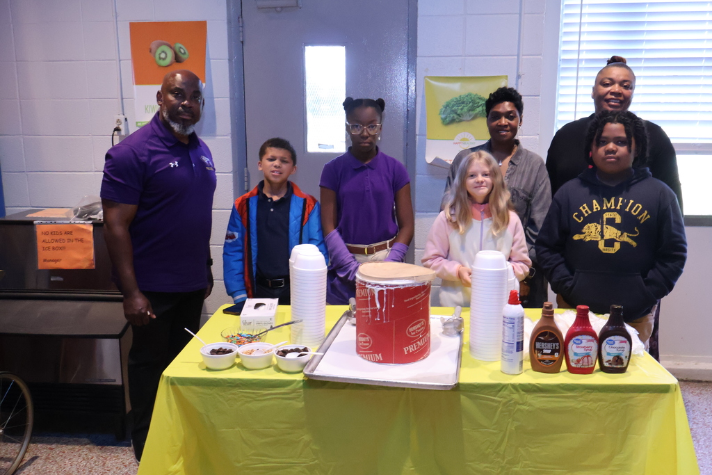 Students at Cook Elementary help serve ice cream to their teachers.