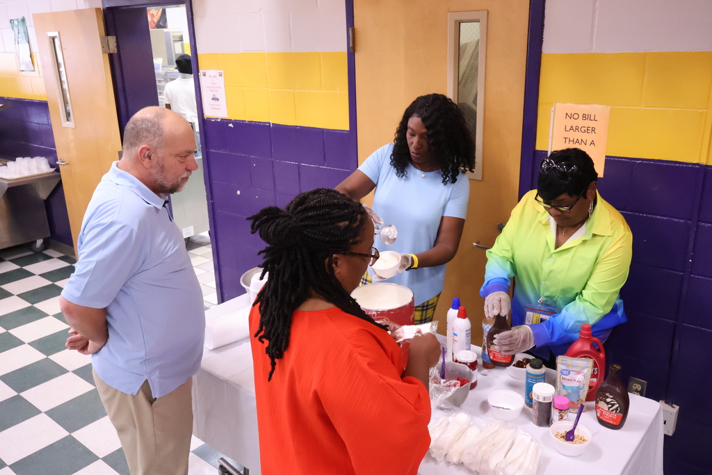 Central office staff serve teachers at Columbus High ice cream. 