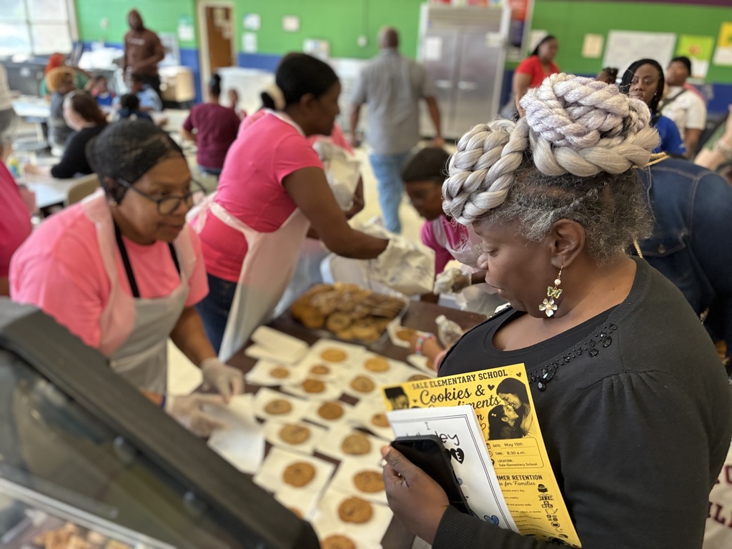 A parent enjoys accepts a cookie during "Cookies with Mom" on Friday morning.