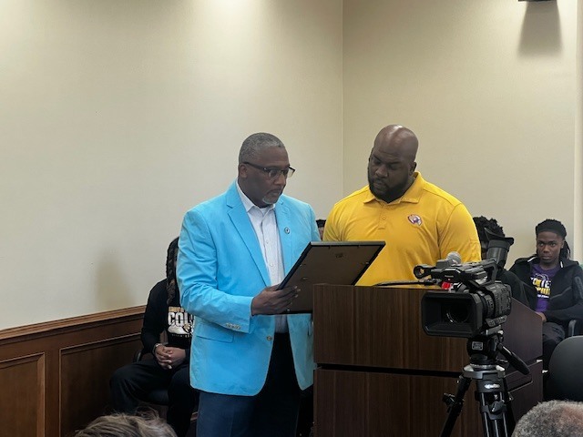 Lowndes County Supervisor Jeff Smith presents CHS Basketball Coach Phillip Morris with a resolution honoring his team's 5A State Championship. 