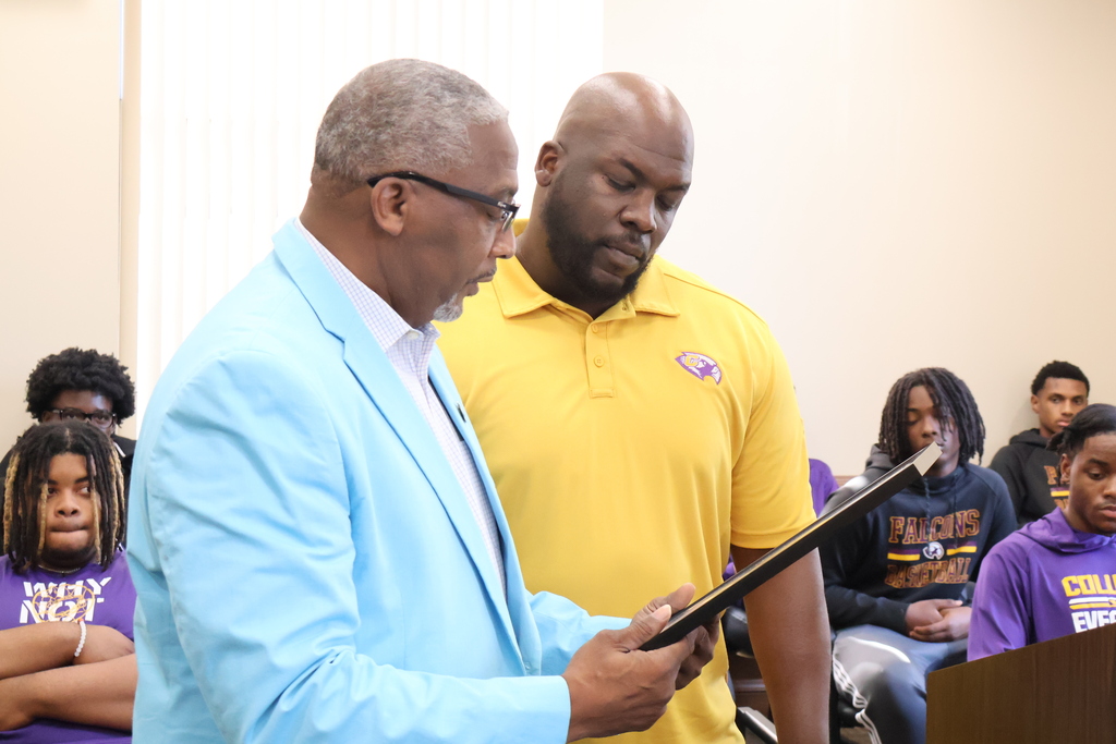 Lowndes County Supervisor Jeff Smith presents CHS Basketball Coach Phillip Morris with a resolution honoring his team's 5A State Championship. 