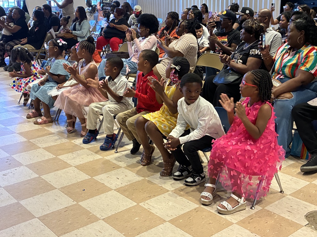 Students and parents clap at the Fairview Elementary Kindergarten Graduation ceremony.