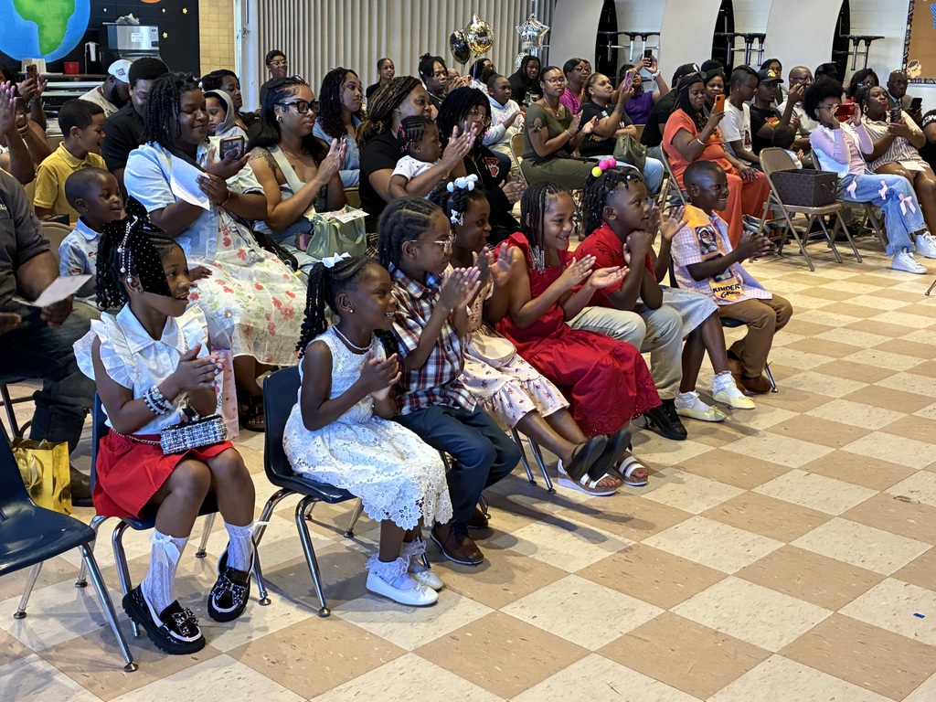 Students and parents clap at the Fairview Elementary Kindergarten Graduation ceremony.