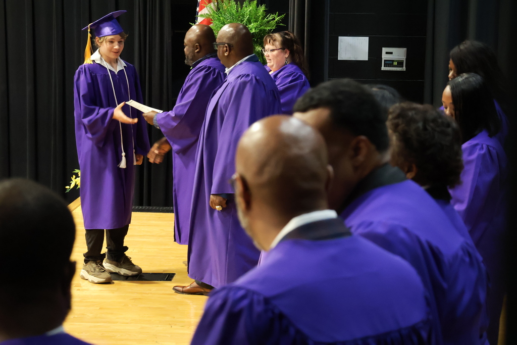 Columbus Middle School hosted its 8th grade graduation ceremony on Friday afternoon. A student receives his certificate on stage.