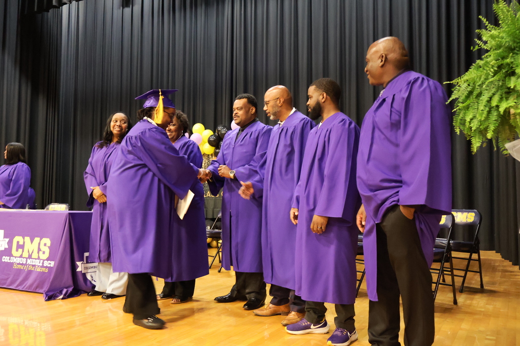 Columbus Middle School hosted its 8th grade graduation ceremony on Friday afternoon. A student receives their certificate on stage.