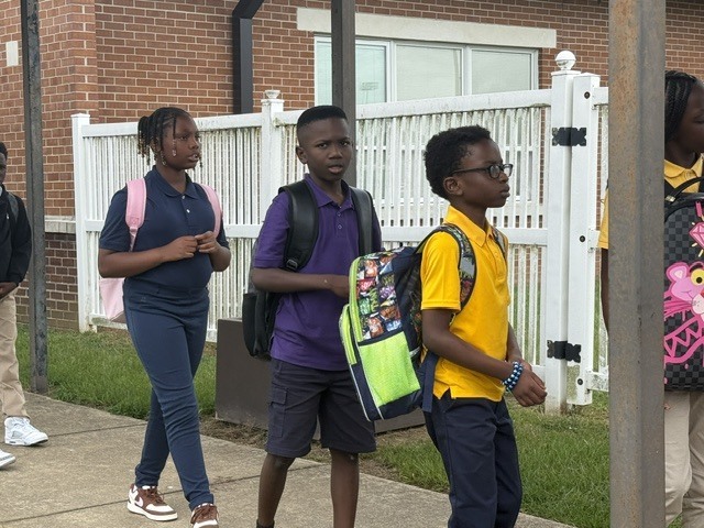 Students wait on the bus at Sale Elementary. 