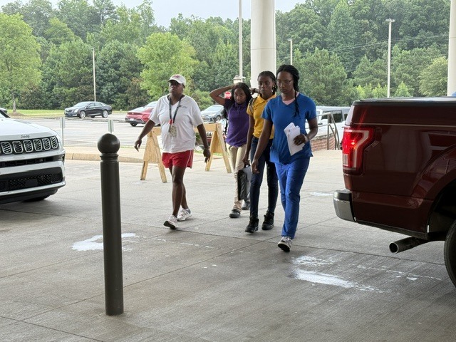Parents walk with their Columbus Middle School students inside the building.
