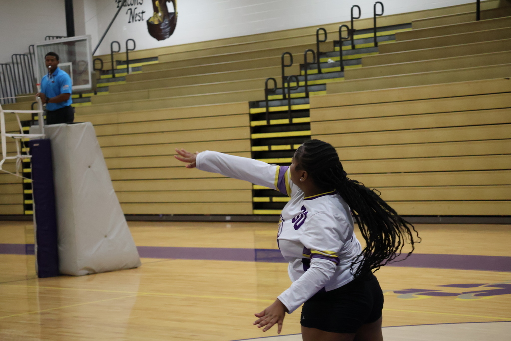 Columbus High volleyball player serves the ball during a game. 