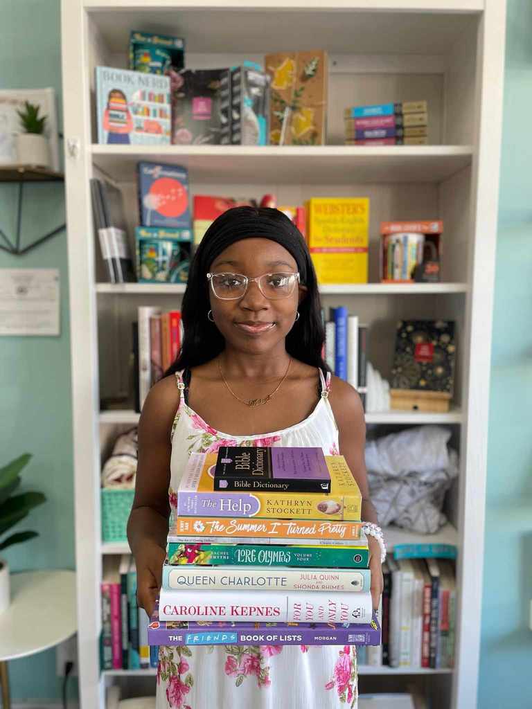 CHS student poses with book display