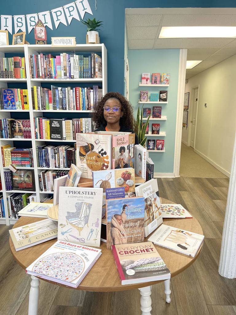 CHS student poses with a display of books