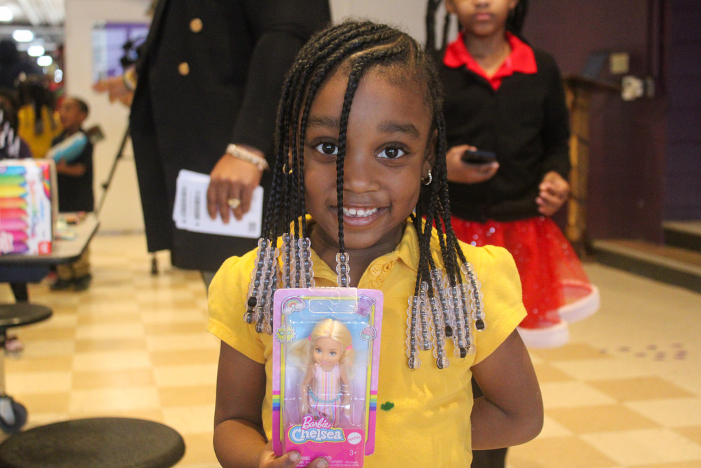 student shows off her new barbie