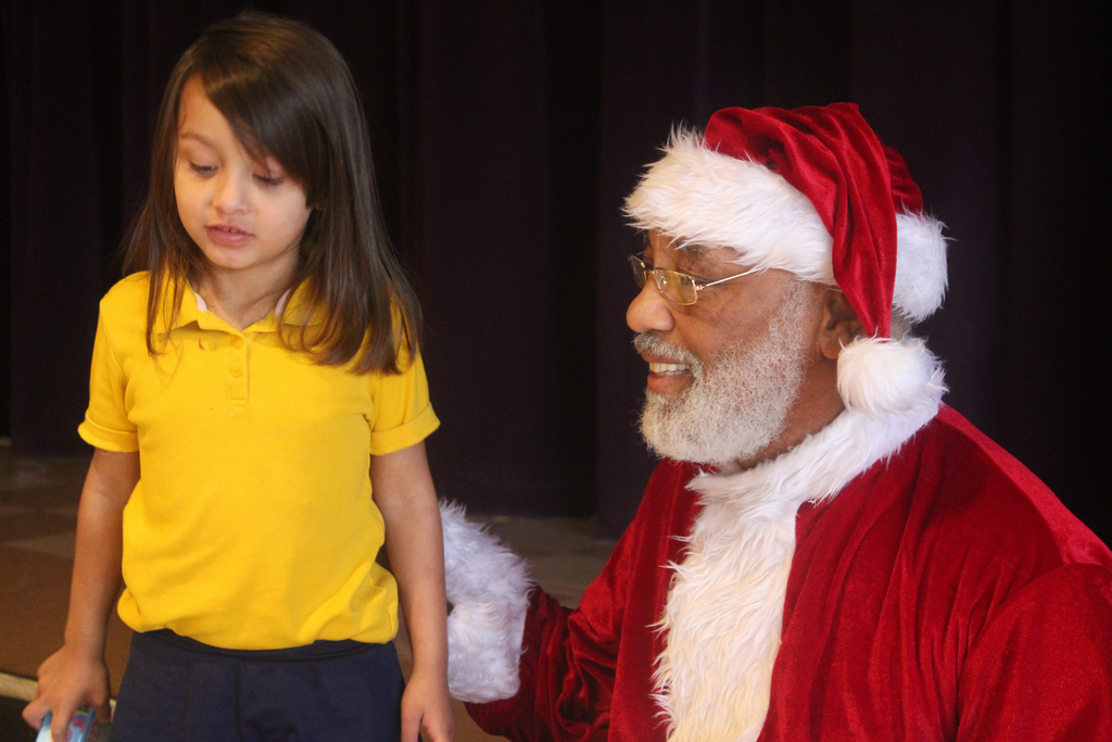 Santa wishes little girl a merry christmas