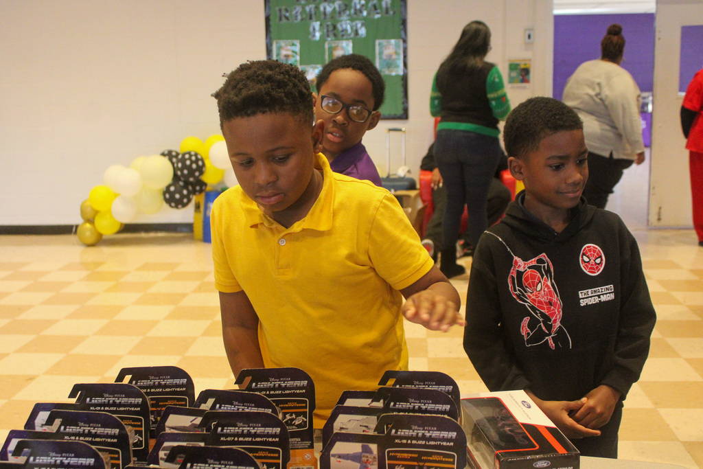 students looking through toys