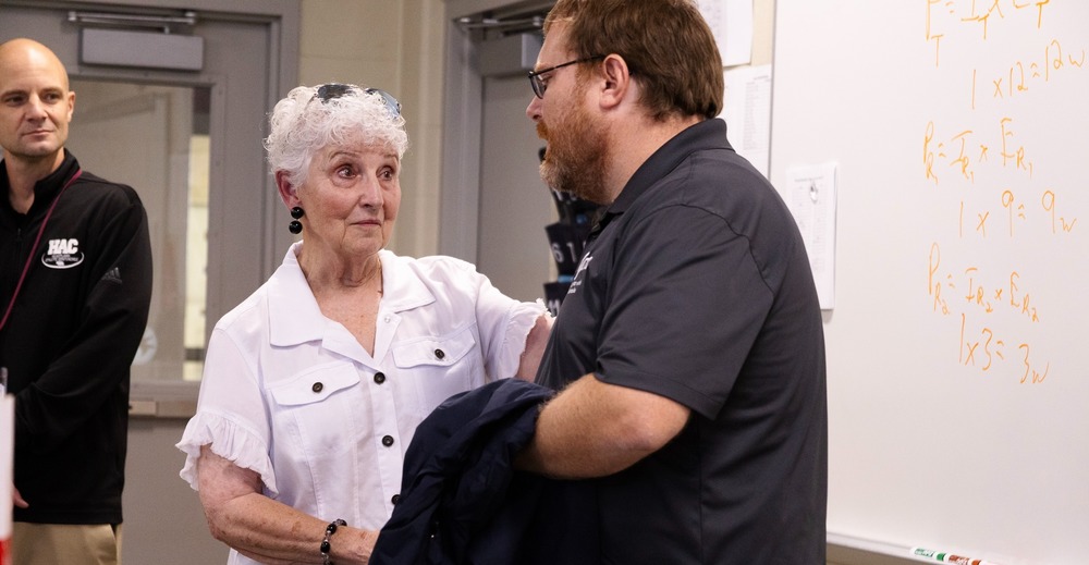 Diane Bartels, the Aerospace Education Vice President for the AFA Lincoln Chapter 187 shakes the hand of CHS Teacher Adam Whitmore.