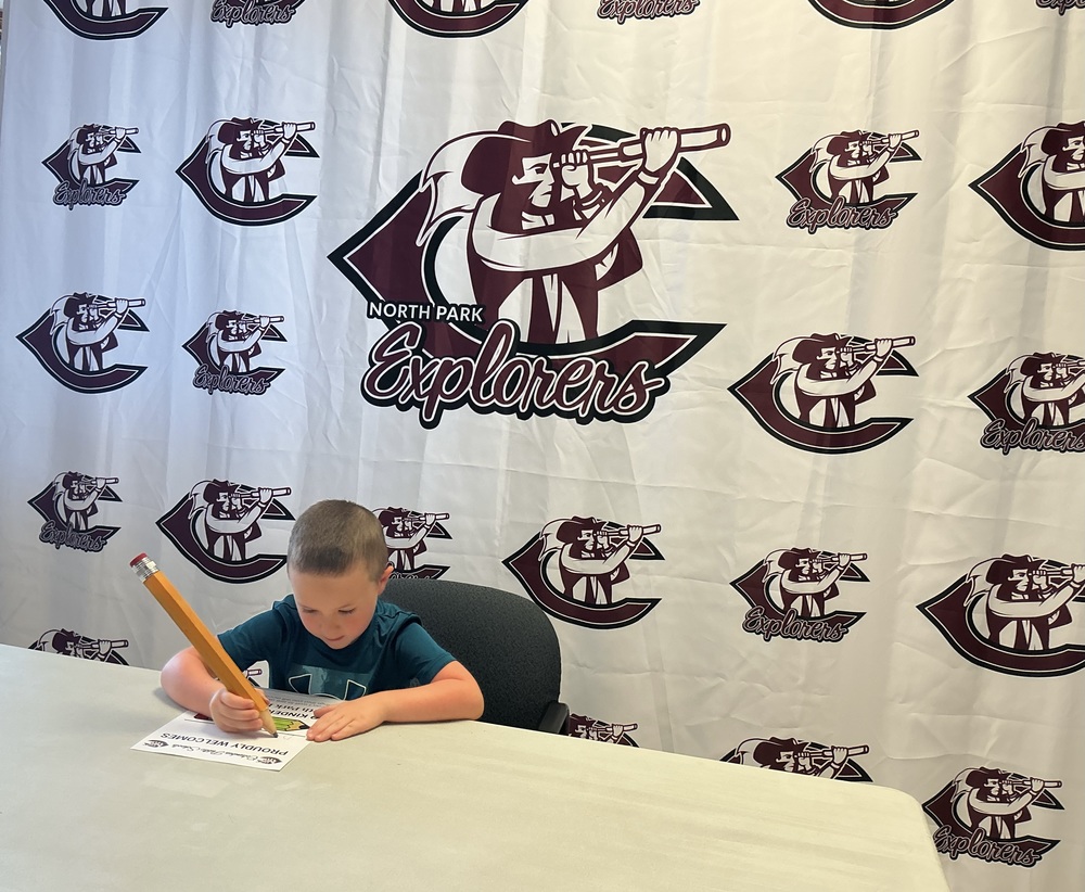 Student signing paper