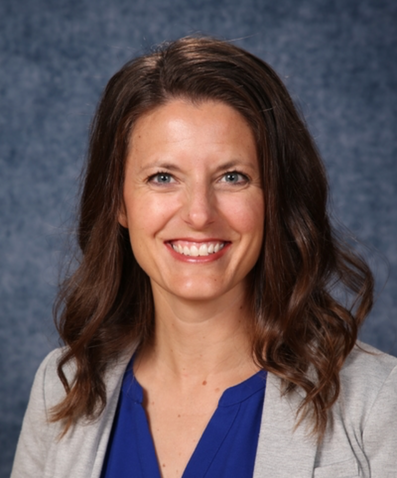 Photo of Brooke Kavan wearing grey blazer with blue top