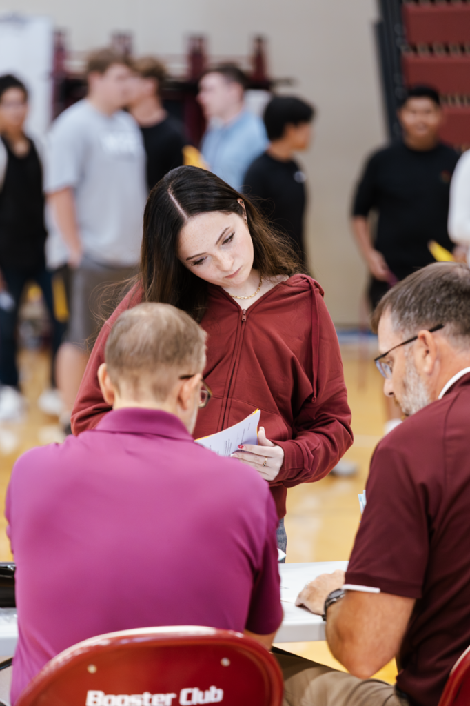 Two CHS teachers help a sophomore confirm her schedule during orientation. 