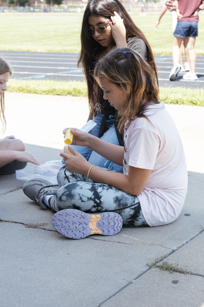 A pair of CMS 5th-graders select pieces of sidewalk chalk during ALO time on their first day.