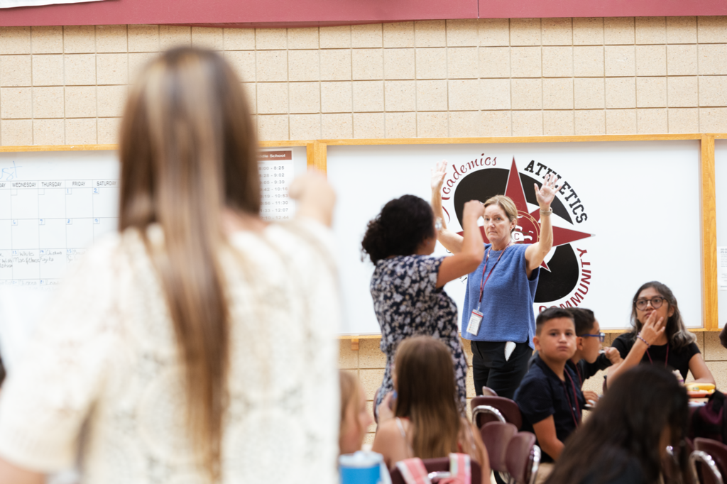 A group of teachers identify themselves during an announcement at lunch. The 5th-graders had their first day at CMS.