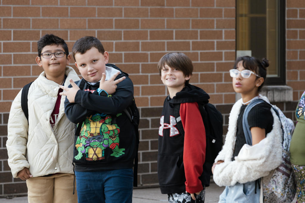 A group of Emerson boys pose for a photograph while waiting the first day of fourth grade in 2025.