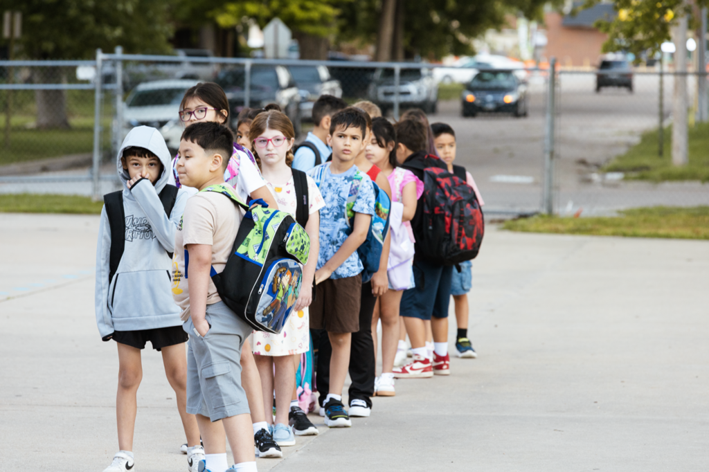 A line of Emerson students wait to be led inside before the first day of school in 2025.