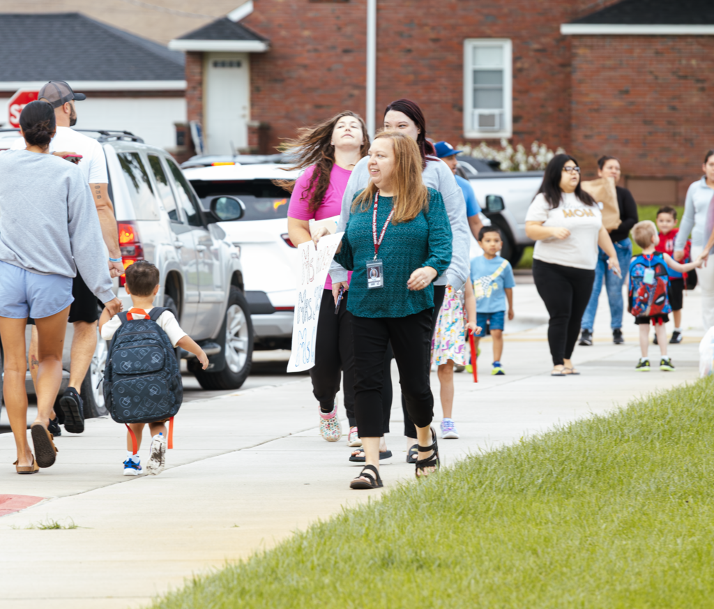 Kramer Preschool Principal Erin Meyer walks the path outside the entrances during the first morning at the school.