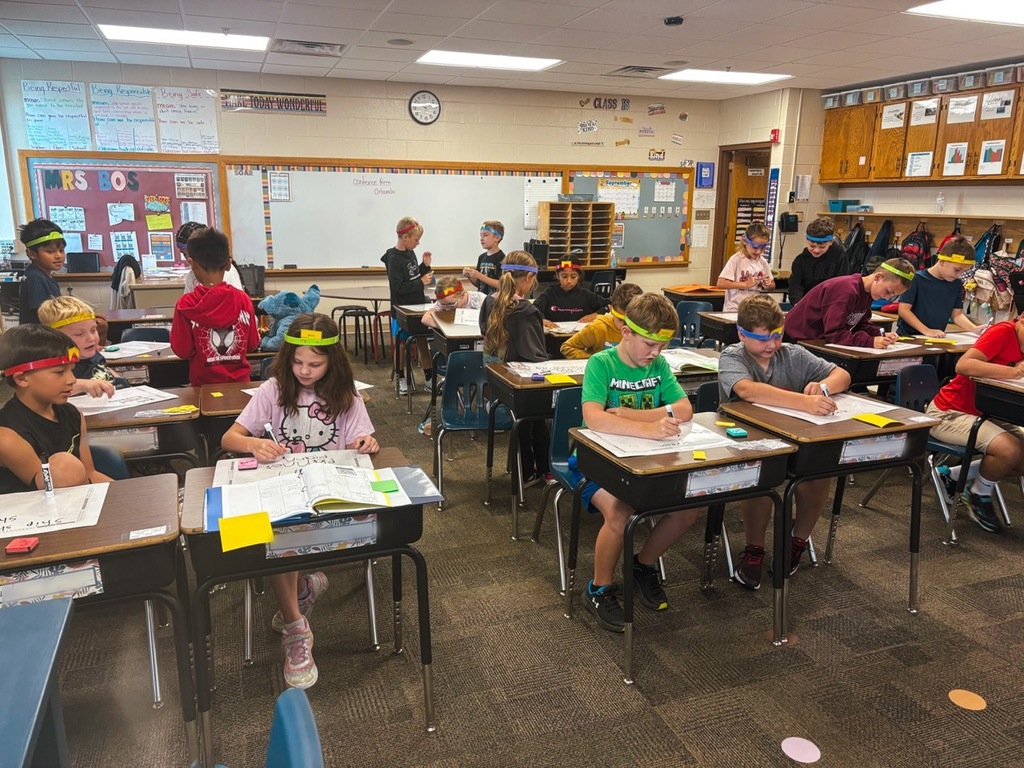 3rd grade working on spelling using the headband game.
