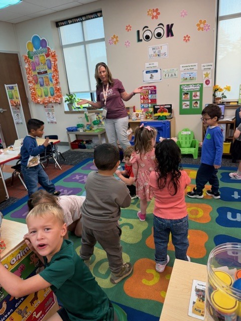 Ms. O. teaching during music and movement time